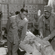 A Marine psychiatrist and a hospital corpsman tend to a wounded Marine at a field hospital in Okinawa, 1945